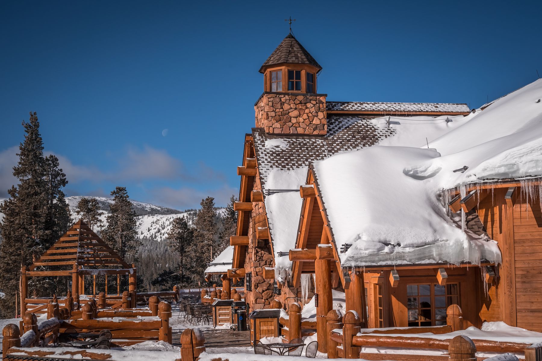 Winter Park lodge beneath snow-covered mountain terrain