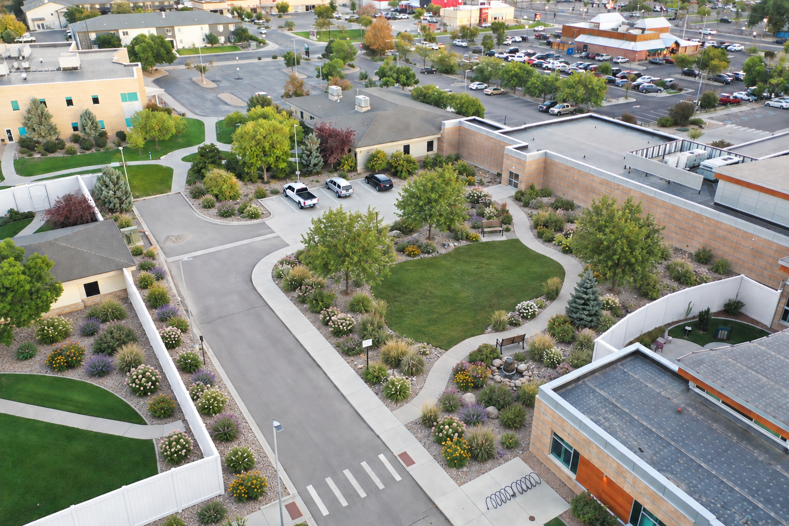 Concept visualization of the grounds with proposed white fencing and landscaped outdoor spaces